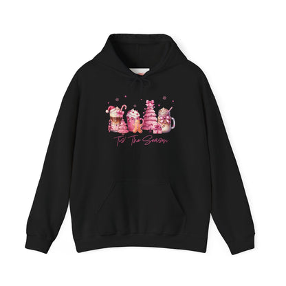 hope + joy collective black hoodie sweatshirt with "Tis the Season" in cursive font below a graphic image of seasonal coffee and cocoa drinks accented in pink with a pink Christmas tree topped with pink bow