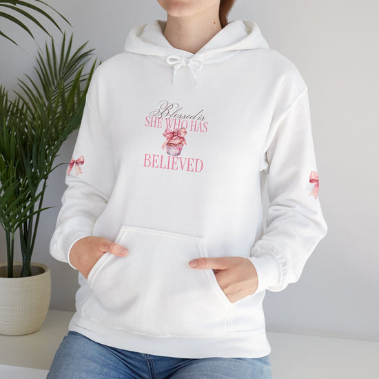  White hoodie with cute pink cupcake with bow and bows on sleeves, says "blessed is she who has believed"