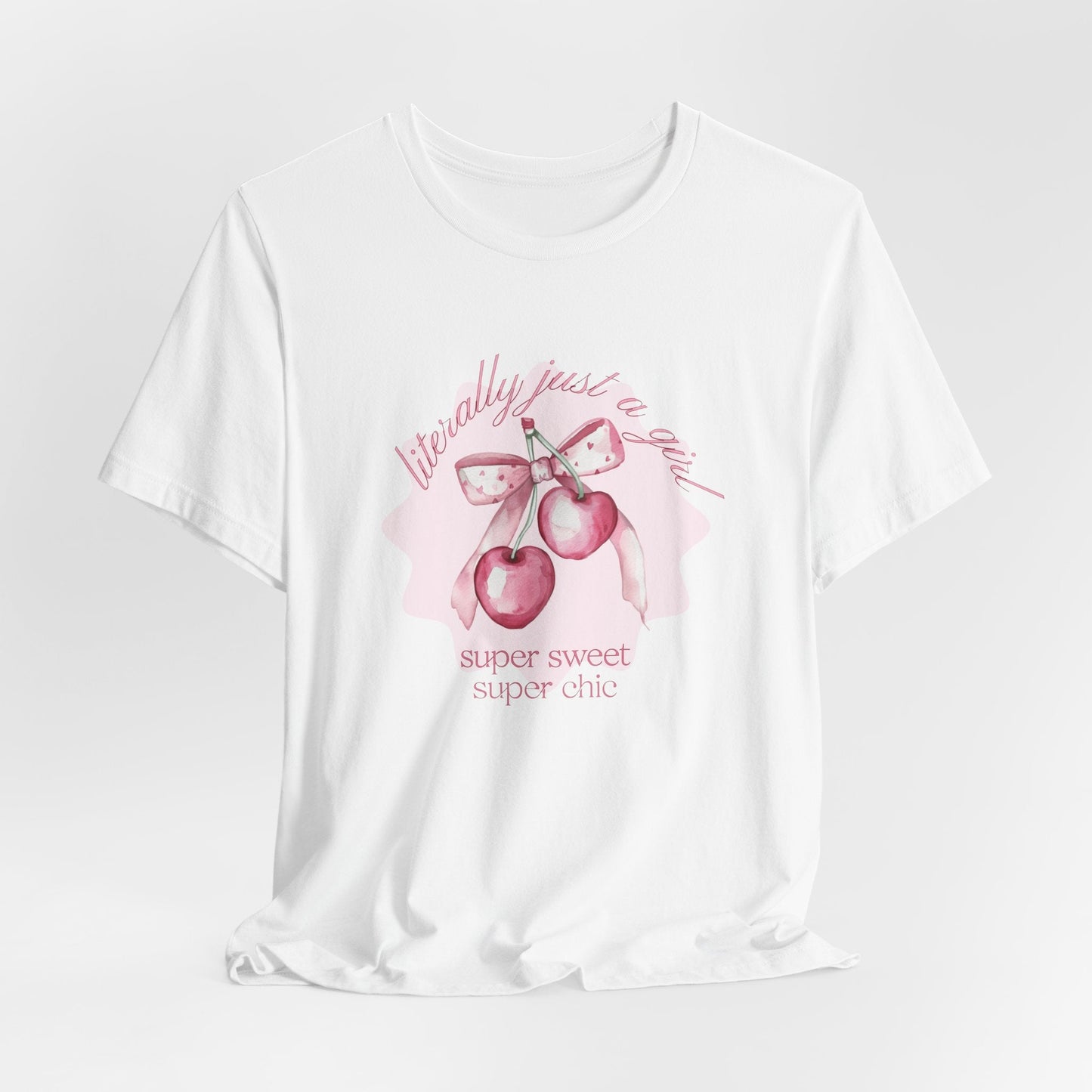 hope + joy collective white short sleeve t-shirt hanging with image of pink cherries with pink bow that says "literally just a girl, super sweet, super chic"