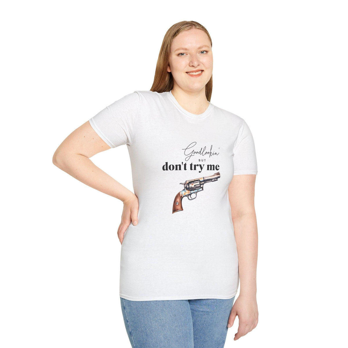 female model in jeans wearing hope + joy collective T-Shirt XS - 5X White that says "Goodlookin' But Don't Try Me" with a revolver graphic image