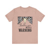 hope + joy collective heather prism peach short sleeve t-shirt with a graphic image of a leopard banner and cow skull in the middle that says "Should've Come with a Warning" in western font
