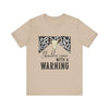 hope + joy collective tan short sleeve t-shirt with a graphic image of a leopard banner and cow skull in the middle that says "Should've Come with a Warning" in western font