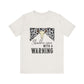 hope + joy collective heather vintage white short sleeve t-shirt with a graphic image of a leopard banner and cow skull in the middle that says "Should've Come with a Warning" in western font