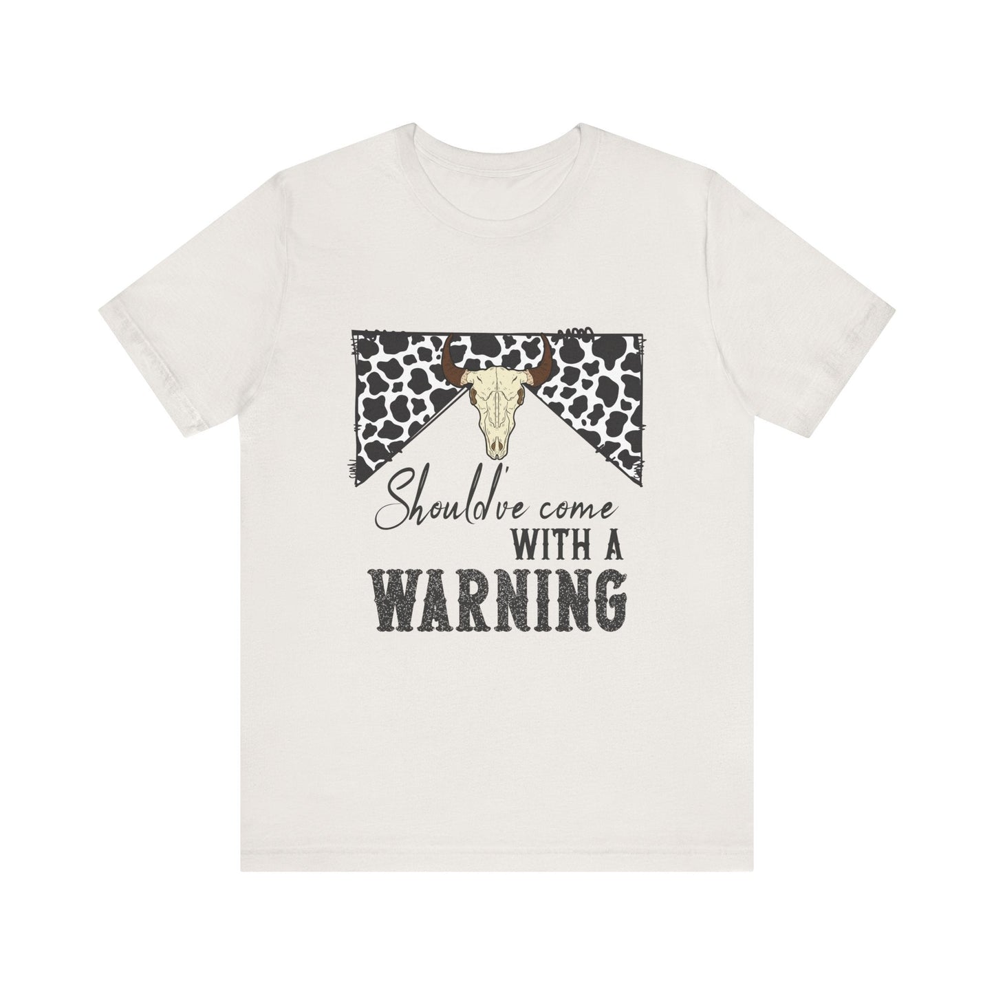 hope + joy collective heather vintage white short sleeve t-shirt with a graphic image of a leopard banner and cow skull in the middle that says "Should've Come with a Warning" in western font