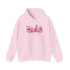 hope + joy collective pink hoodie sweatshirt with "Tis the Season" in cursive font below a graphic image of seasonal coffee and cocoa drinks accented in pink with a pink Christmas tree topped with pink bow