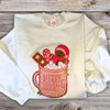 hope + joy collective apparel Merry and Bright white Crewneck Sweatshirt with chenille patch outlined in sparkling gold of large pink mug with cute gingerbread man cookie, candy cane and marshmallows sitting in a pink mug of hot cocoa with Merry & Bright printed on front. 