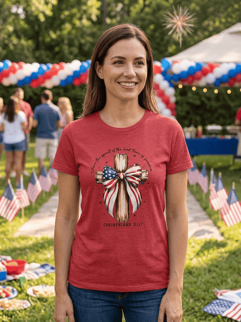 hope + joy collective red T-Shirt with cross with red, white and blue bow and 1 Corinthians 3:17 in scripted font curved around the graphic image