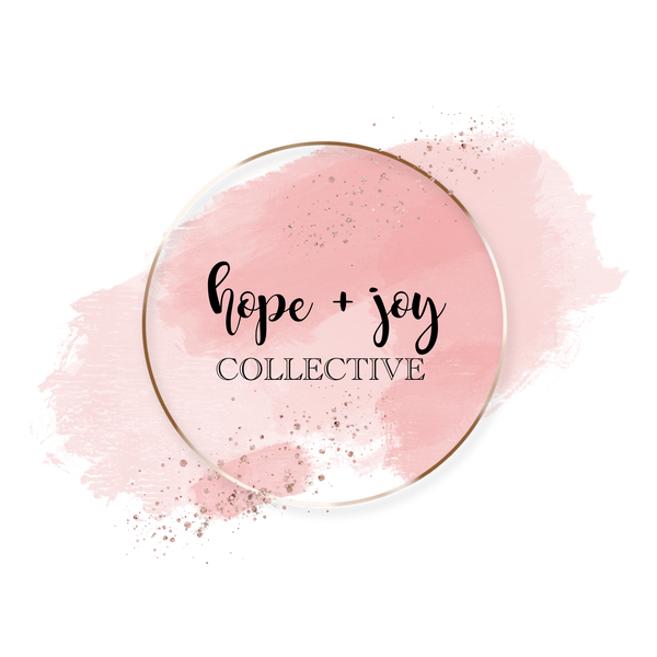 hope and joy collective logo of varied light pink smudges with metallic gold ring and specks of gold glitter sprinkled across bottom left area and top right area with "hope + joy" in hand-lettered cursive font and "Collective" below it in all caps serif font