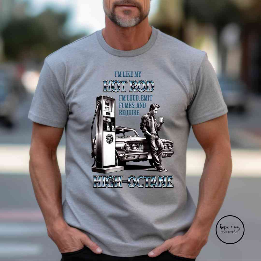 High Octane T-Shirt, funny classic car t-shirt reads "I'm like my hot rod I'm loud, emit fumes, and require high octane with drawn image of a guy leaning against his vintage car at the gas pump sipping coffee